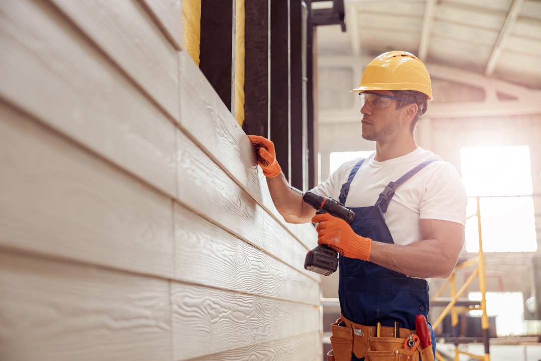 home siding, a man installing siding