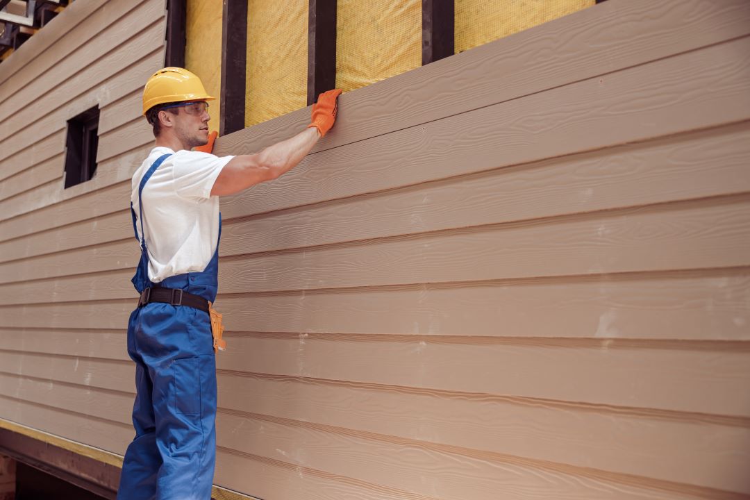 home siding, a man installing siding