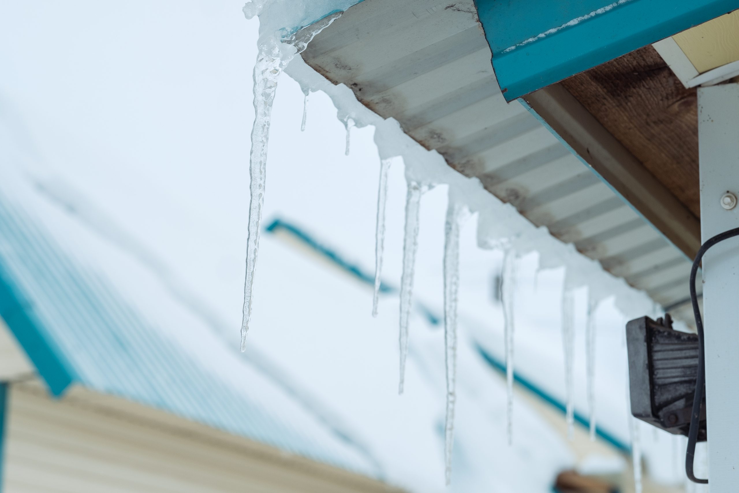 roofing in the winter, frozen ice at the edge of a roof