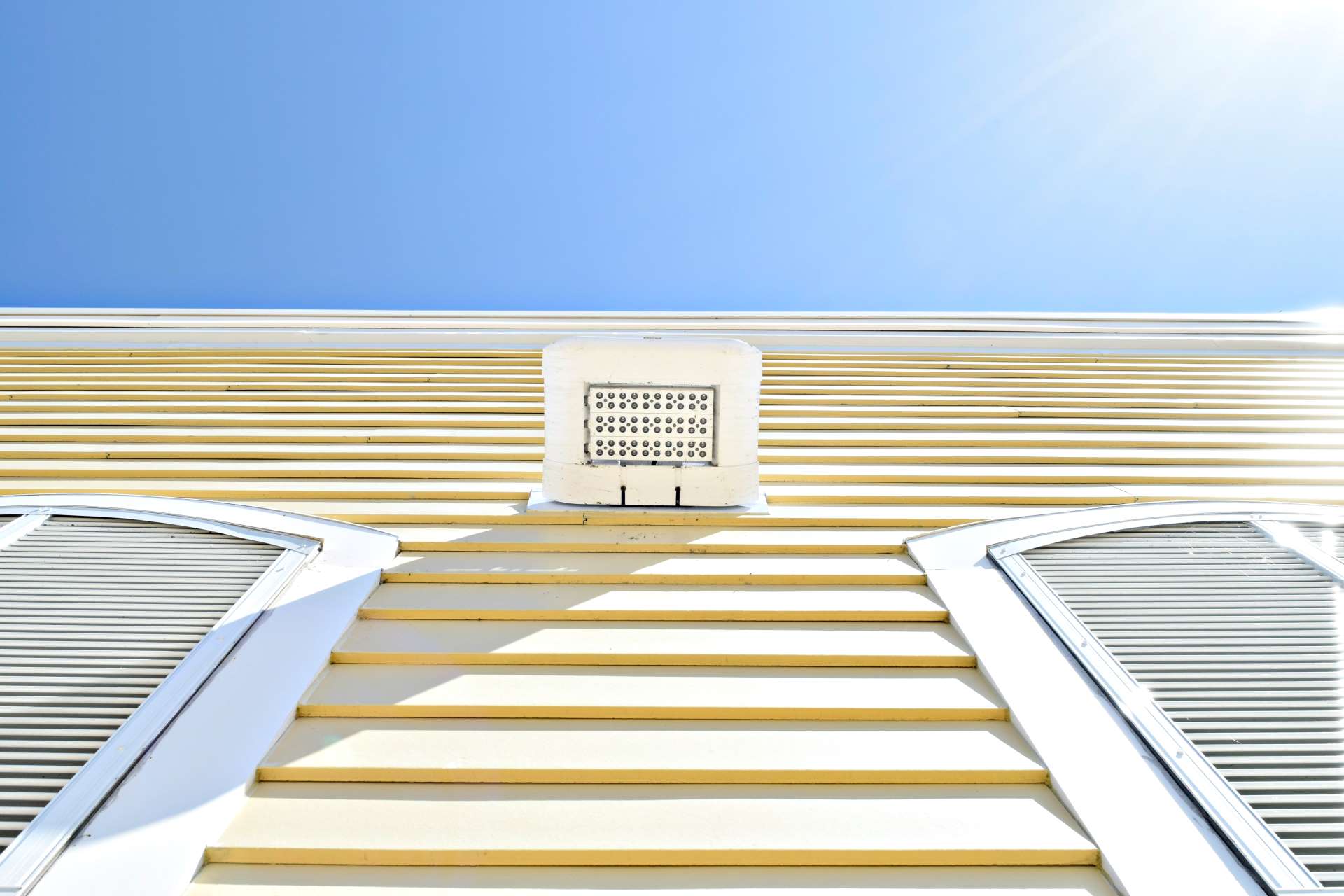tips for energy efficiency. bright and tropical yellow house siding.