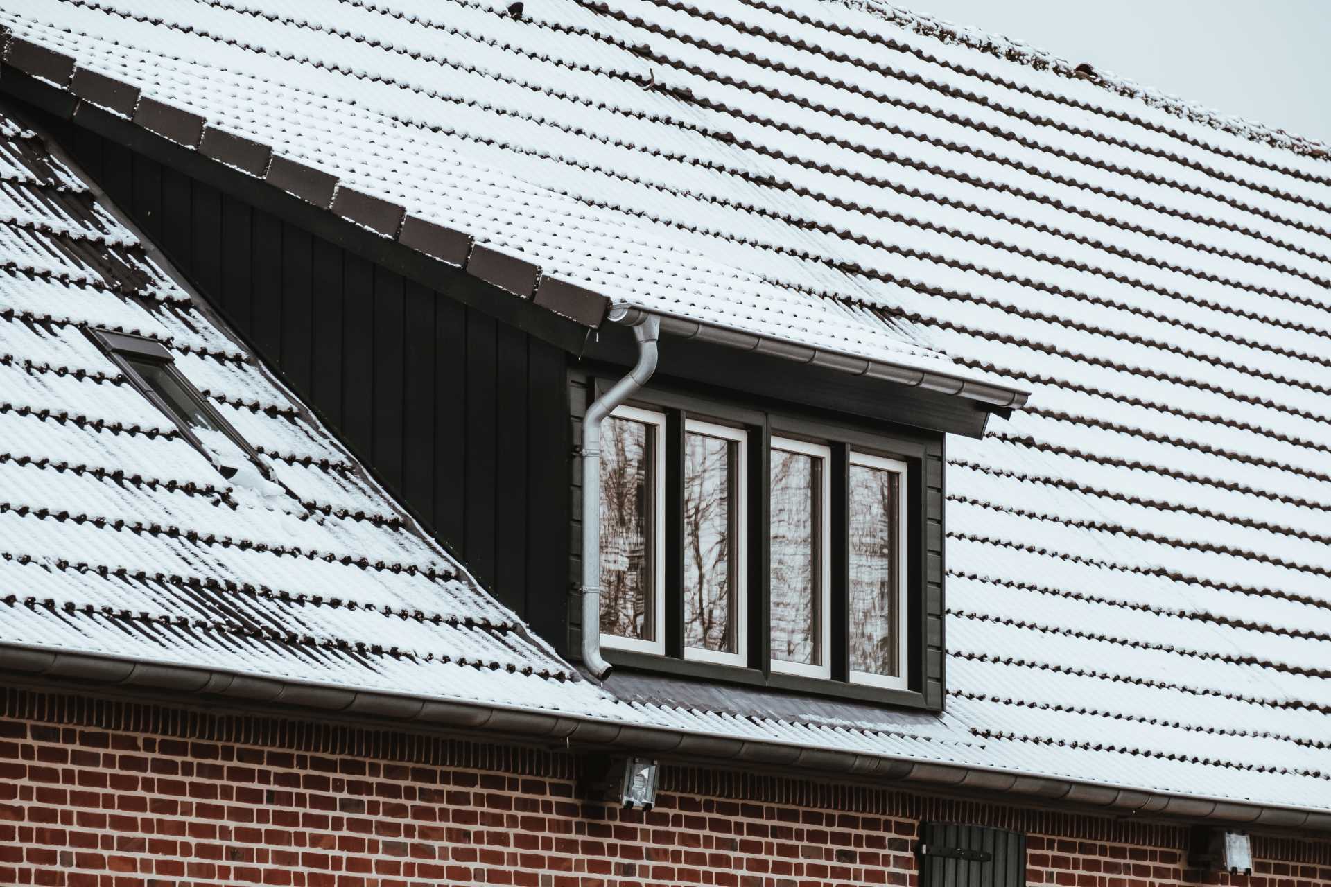 winter roof repair, roof a house covered by snow in the winter.