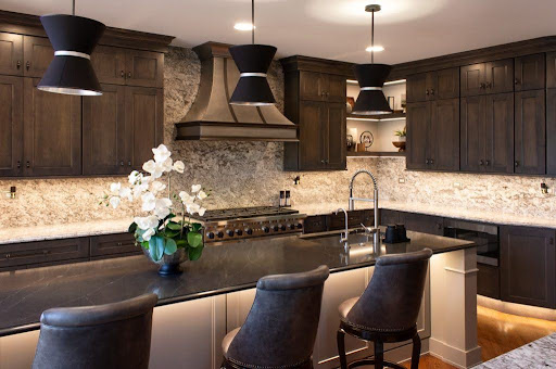 Dark wood kitchen with stone backsplash and pendant lighting—custom Kitchen Renovation on Long Island, NY.