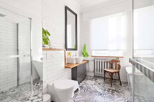 Modern bathroom with soaking tub, glass shower, and statement lighting by the Best Bathroom Renovation Contractor