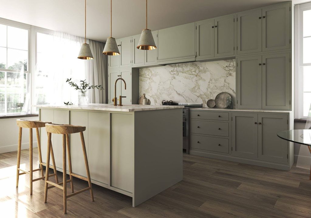 Modern kitchen with light gray cabinets, marble backsplash, an island with two wooden stools, pendant lights, and large windows letting in natural light.