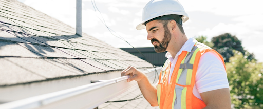 Roof inspection checklist in progress with focus on gutters and roof maintenance tips.