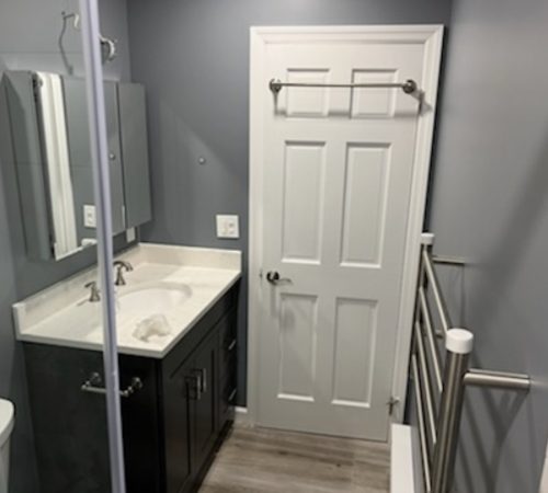 1 Elegant bathroom renovation by one of the top bathroom remodeling companies in Jericho, showcasing modern tiles and a custom vanity