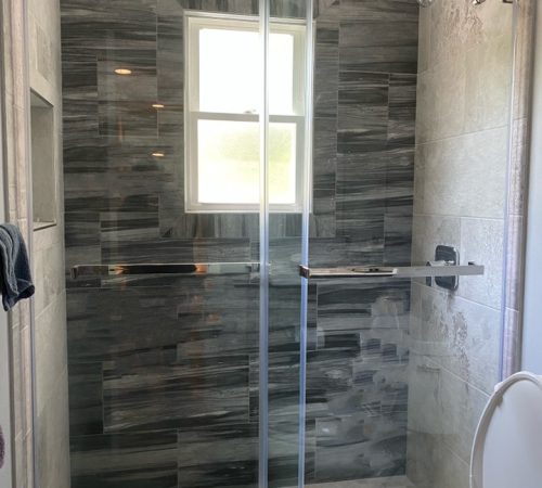 1 Modern bathroom remodeling project in Mineola with sleek tile and fixtures.